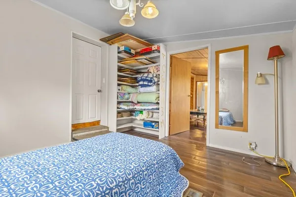 a bedroom with a bed and a large window