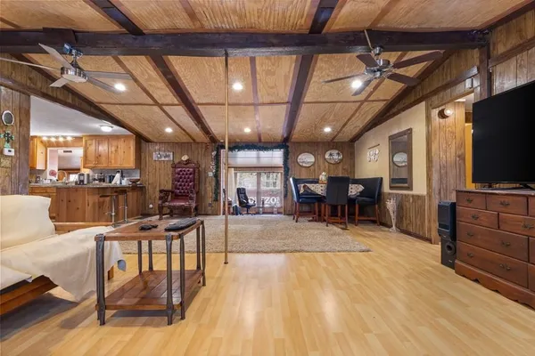 a view of a dining room with furniture a chandelier and wooden floor