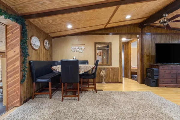 a view of a livingroom with furniture and a flat screen tv