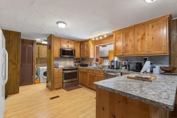 a kitchen with a refrigerator stove top oven and sink