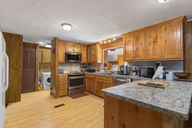 a kitchen with a refrigerator stove top oven and sink