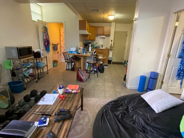 a bedroom with furniture and a flat screen tv