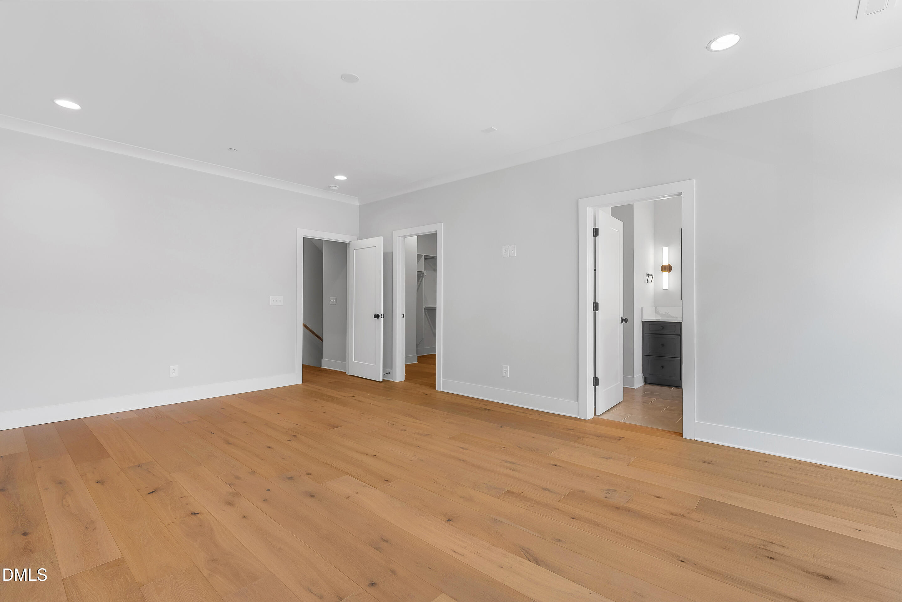 811 Maple Berry Lane, Unit 103 Raleigh, NC 27607 - Photo 24 of 59 a view of an empty room with wooden floor