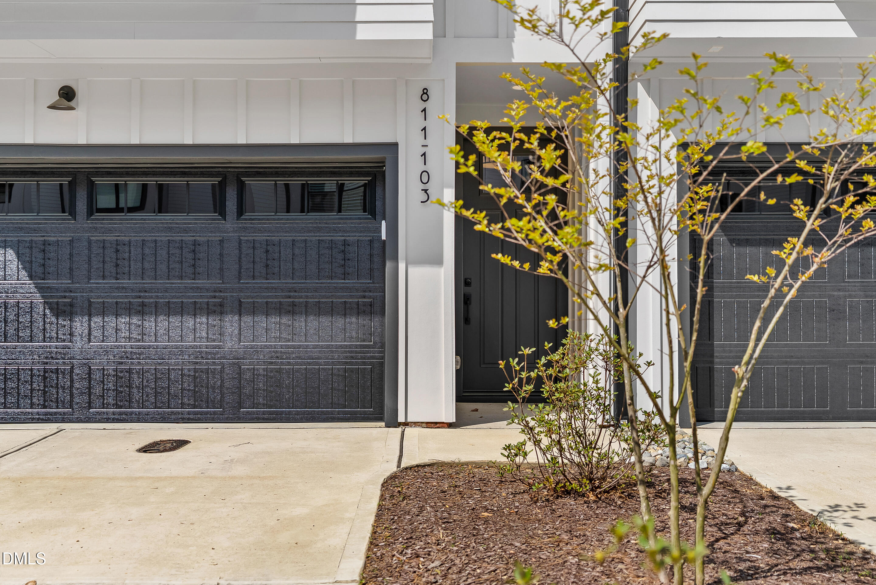 811 Maple Berry Lane, Unit 103 Raleigh, NC 27607 - Photo 3 of 59 a view of entryway with a flower garden