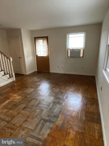 a view of wooden floor and windows in a room