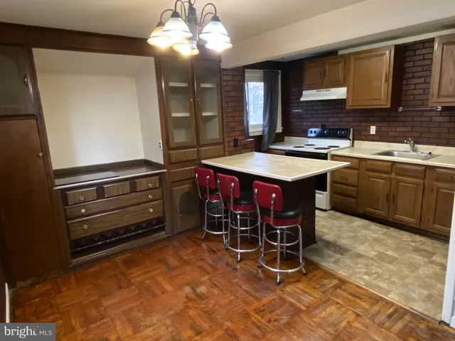 a kitchen with a stove a sink and a refrigerator