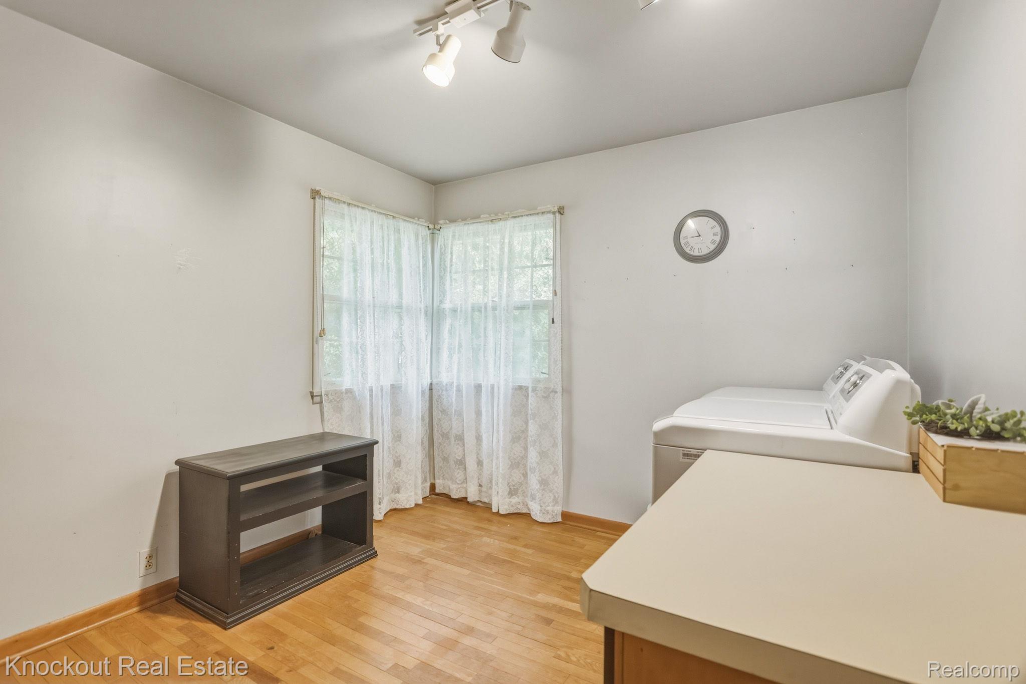 1755 South Reese Road Reese, MI 48757 - Photo 25 of 69 Hardwood flooring with corner windows, track lighting, and a built-in counter surface