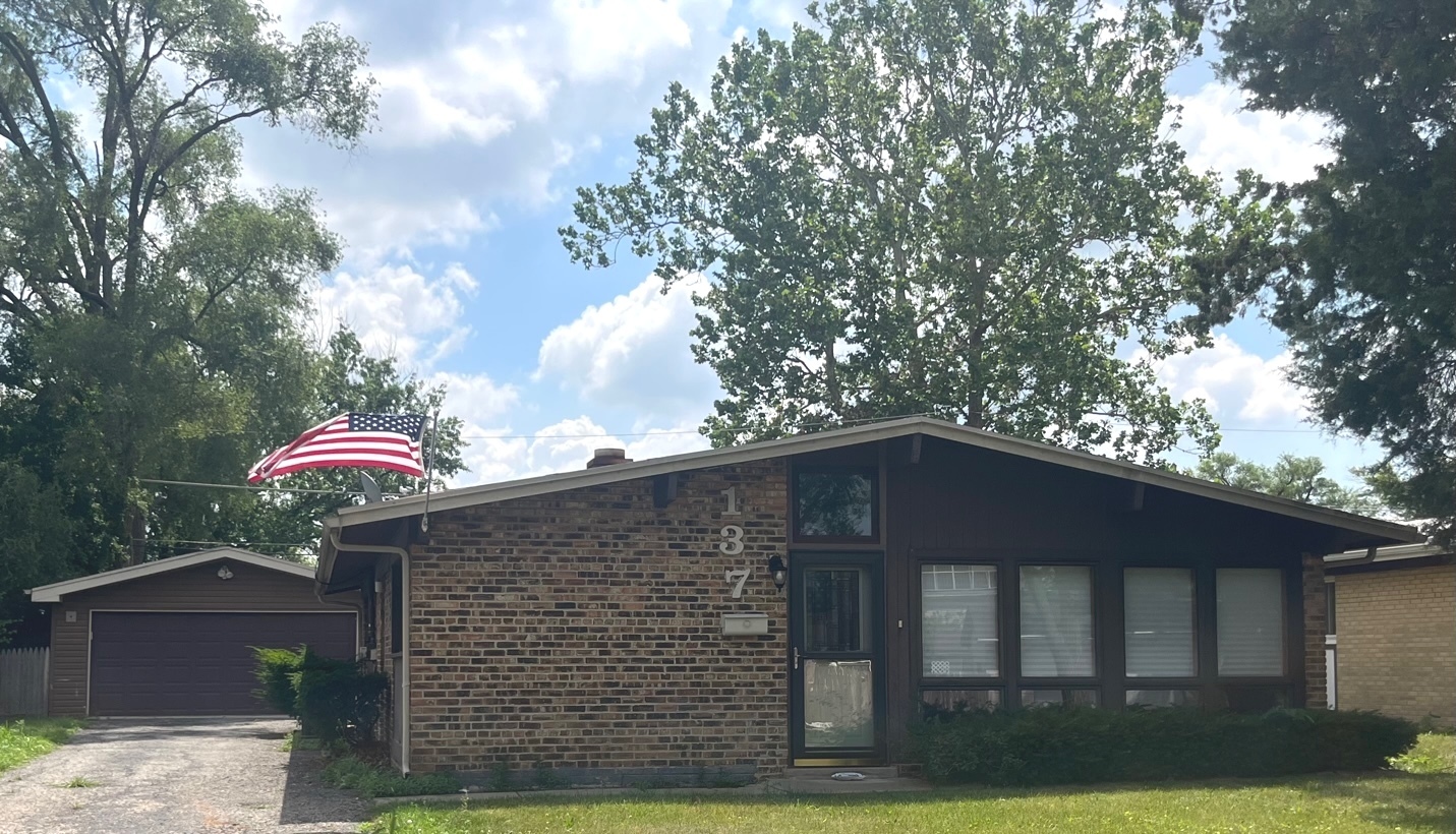 137 Highview Avenue Addison, IL 60101 - Photo 1 of 12 a front view of a house with yard and trees