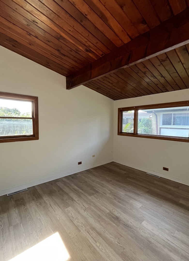 137 Highview Avenue Addison, IL 60101 - Photo 6 of 12 a view of room with wooden floor and windows