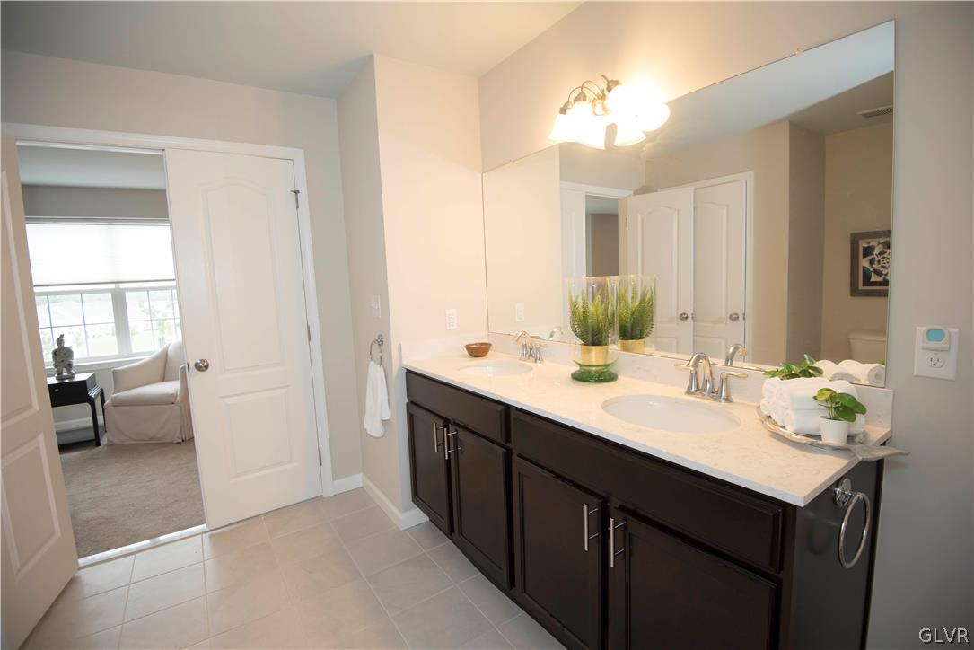 407 Pennycress Road Allentown, PA 18104 - Photo 17 of 34 a bathroom with a sink double vanity and a mirror