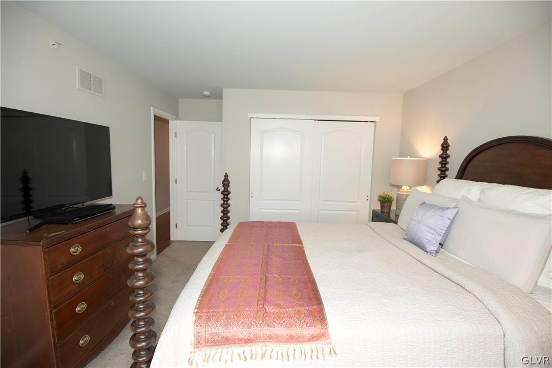 407 Pennycress Road Allentown, PA 18104 - Photo 20 of 34 a bedroom with a bed and a flat screen tv