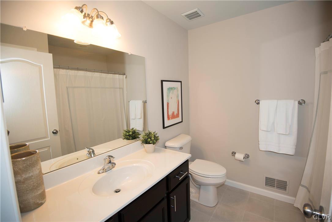 407 Pennycress Road Allentown, PA 18104 - Photo 23 of 34 a bathroom with a toilet sink and mirror