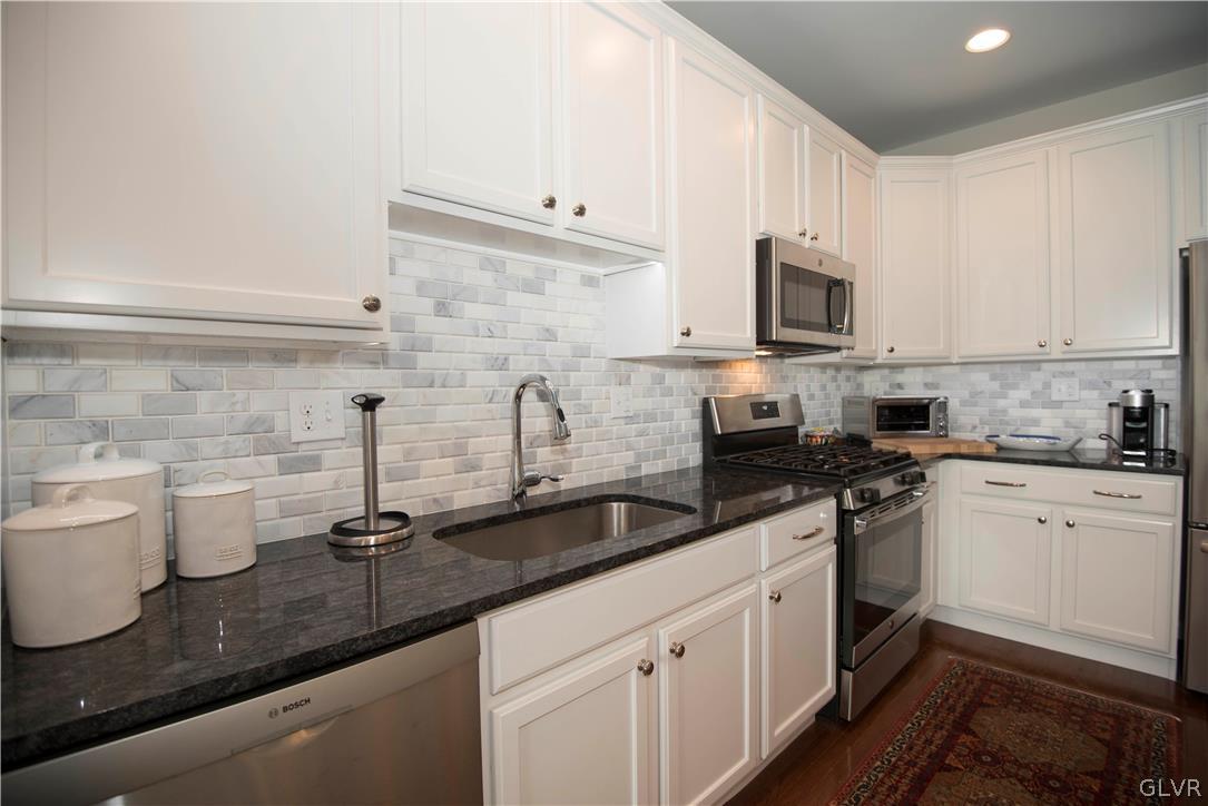 407 Pennycress Road Allentown, PA 18104 - Photo 5 of 34 a kitchen with sink a microwave and cabinets