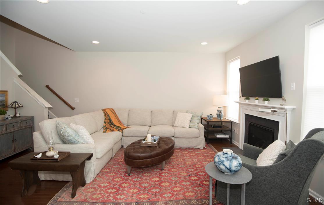 407 Pennycress Road Allentown, PA 18104 - Photo 10 of 34 a living room with furniture a fireplace and a flat screen tv