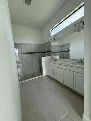 a utility room with cabinets and washer