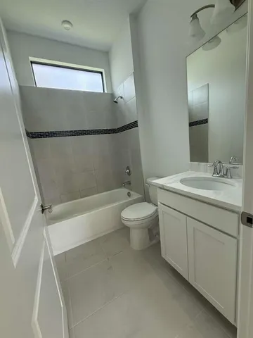 a bathroom with a double vanity sink toilet and shower