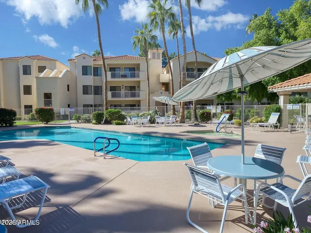 a swimming pool with outdoor seating and yard