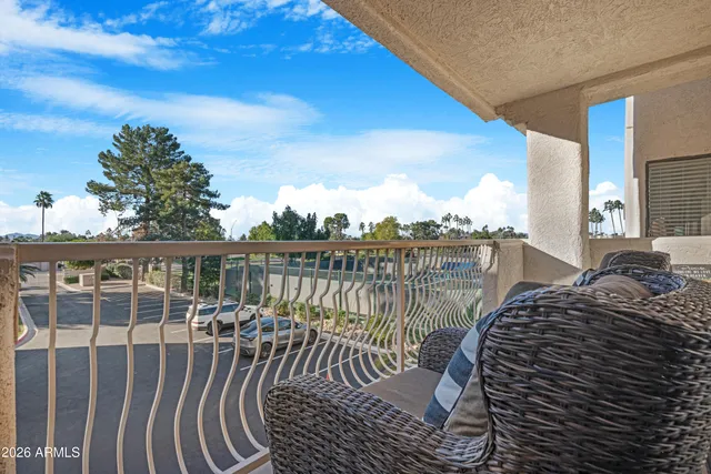 a balcony with table and chairs