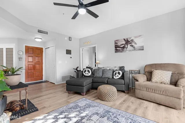 a living room with furniture a rug and a window