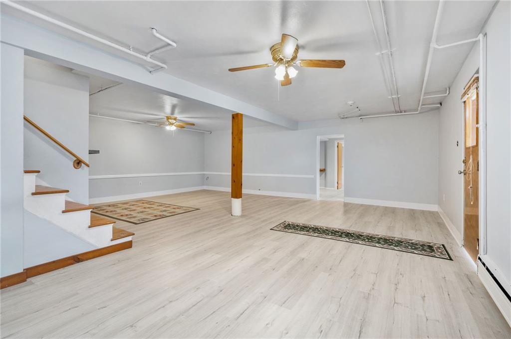 938 McCoy Road McKees Rocks, PA 15136 - Photo 17 of 24 a view of a livingroom with wooden floor and staircase