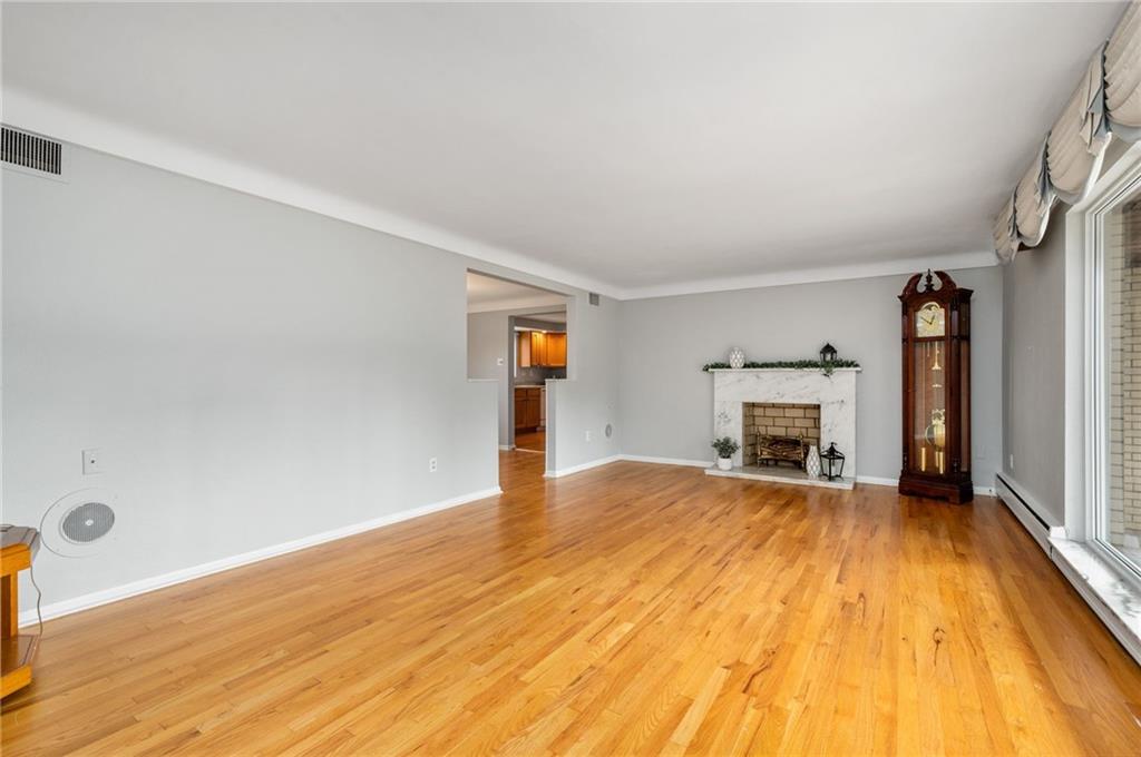 938 McCoy Road McKees Rocks, PA 15136 - Photo 2 of 24 a view of empty room with wooden floor and fireplace