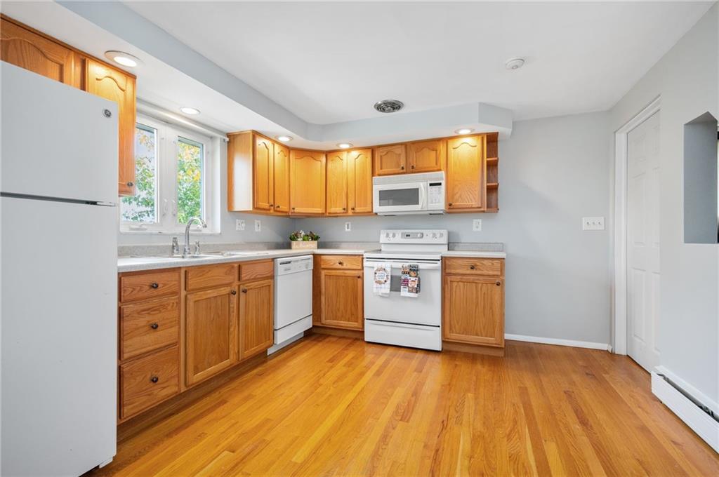 938 McCoy Road McKees Rocks, PA 15136 - Photo 7 of 24 a kitchen with wooden floors appliances and cabinets