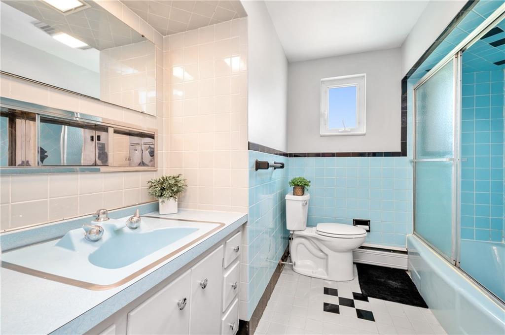 938 McCoy Road McKees Rocks, PA 15136 - Photo 10 of 24 a bathroom with a sink toilet a mirror and shower