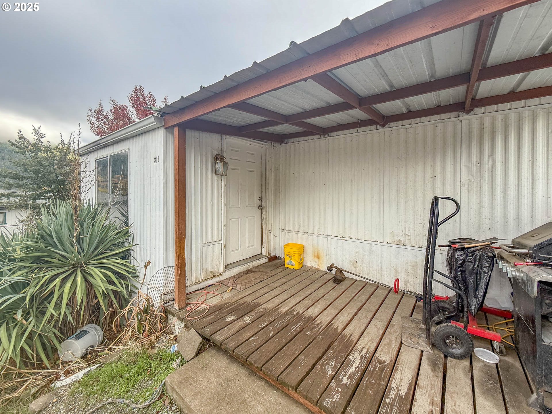 301 Conrad Street Myrtle Creek, OR 97457 - Photo 2 of 12 a bedroom with a bed and a chandelier