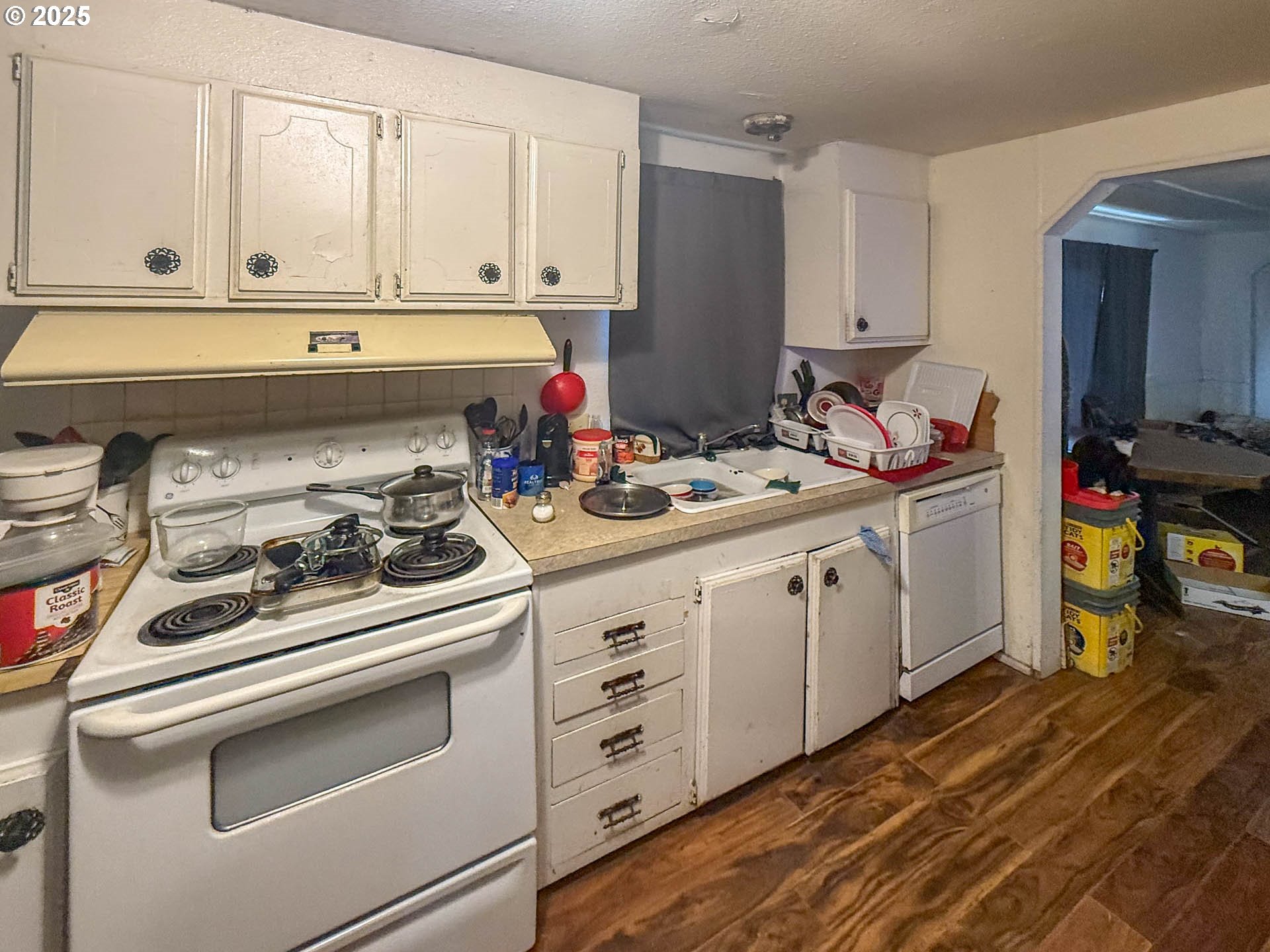 301 Conrad Street Myrtle Creek, OR 97457 - Photo 4 of 12 a kitchen with white cabinets and white appliances