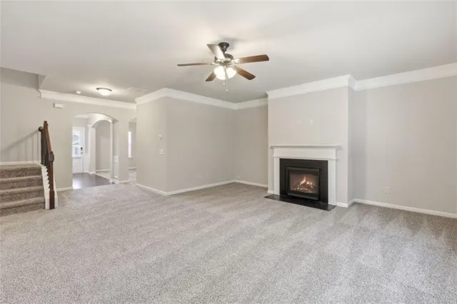 a view of a livingroom with furniture and a ceiling fan