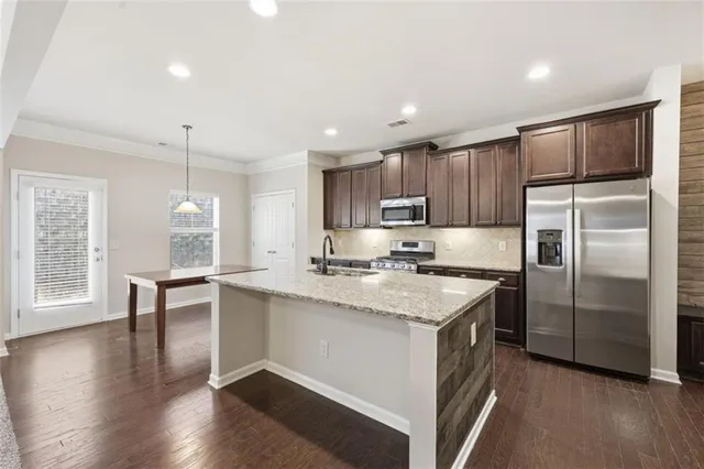 a kitchen with stainless steel appliances granite countertop a stove and a sink