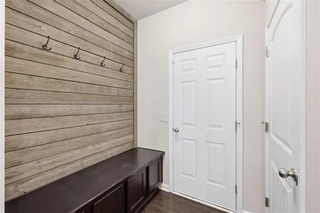 a kitchen with stainless steel appliances kitchen island granite countertop a stove a sink a refrigerator and a wooden floor