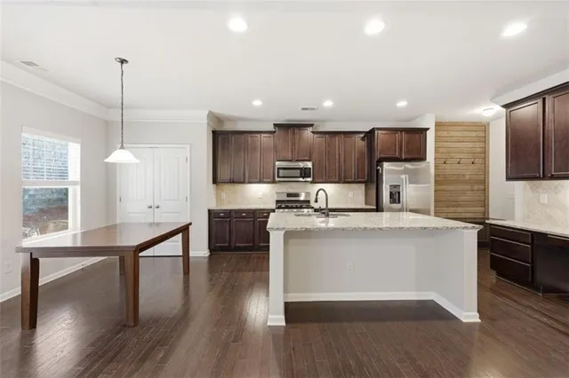 a bathroom with a tub sink shower and mirror