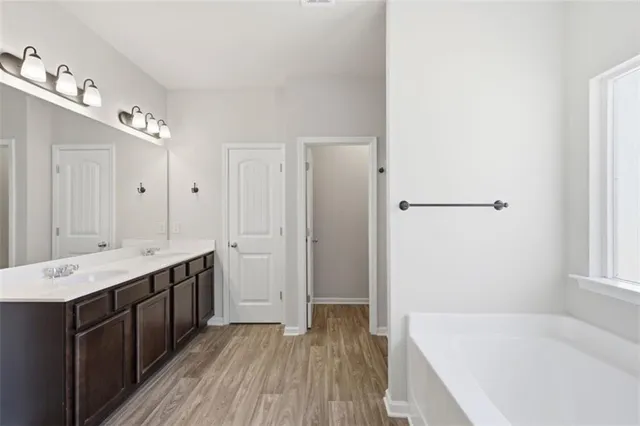 a view of an empty room with chandelier fan