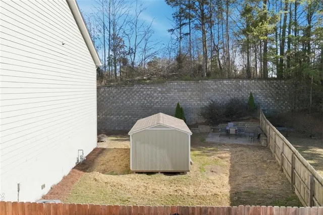 a backyard of a house with table and chairs