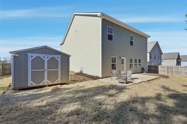 an aerial view of a house with garden space and ocean view