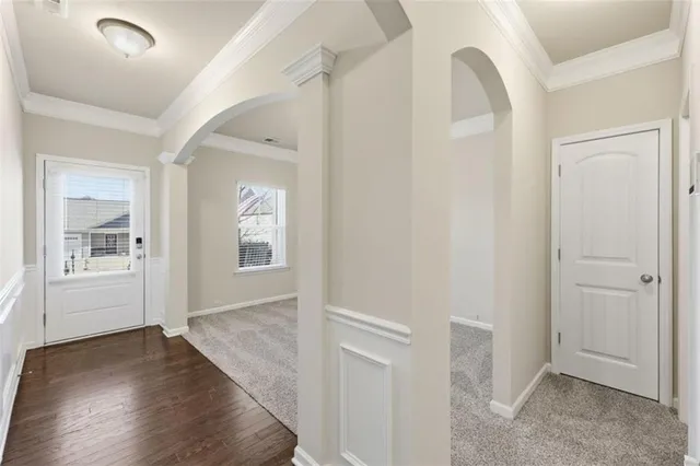 a view of a hallway with wooden floor and stairs