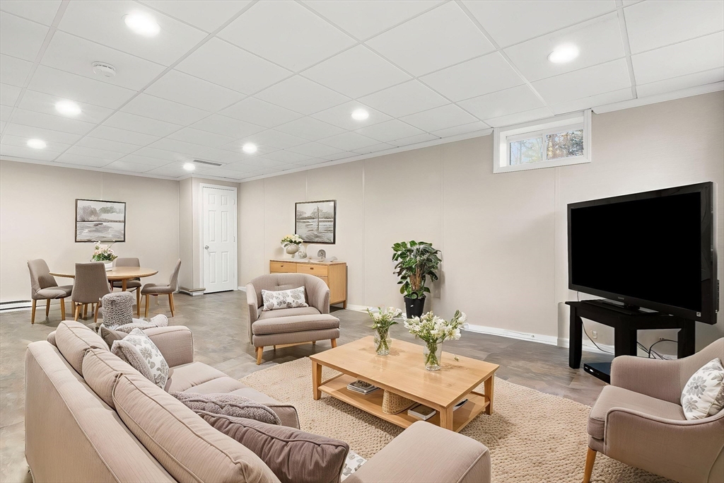 32 Alderbrook Drive Topsfield, MA 01983 - Photo 27 of 40 a living room with furniture and a flat screen tv