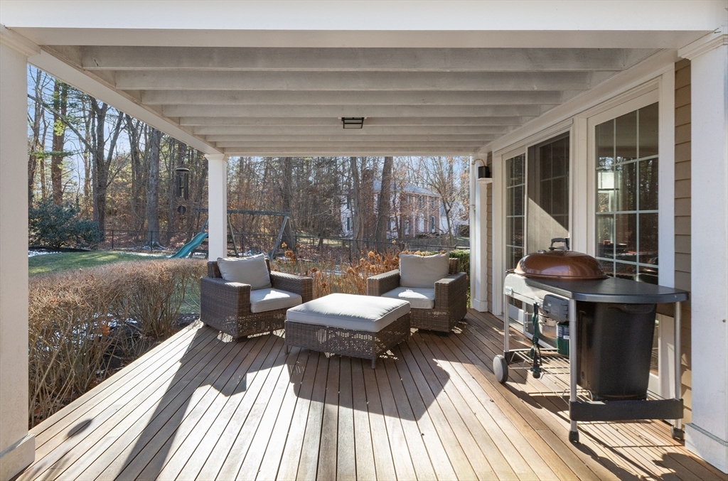 32 Alderbrook Drive Topsfield, MA 01983 - Photo 29 of 40 a view of a patio with lawn chairs floor to ceiling window wooden floor and an outdoor view