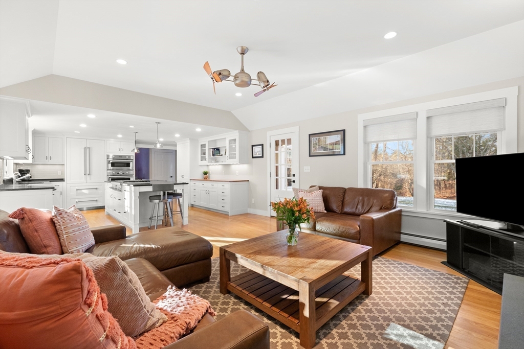32 Alderbrook Drive Topsfield, MA 01983 - Photo 4 of 40 a living room with furniture a flat screen tv and kitchen view