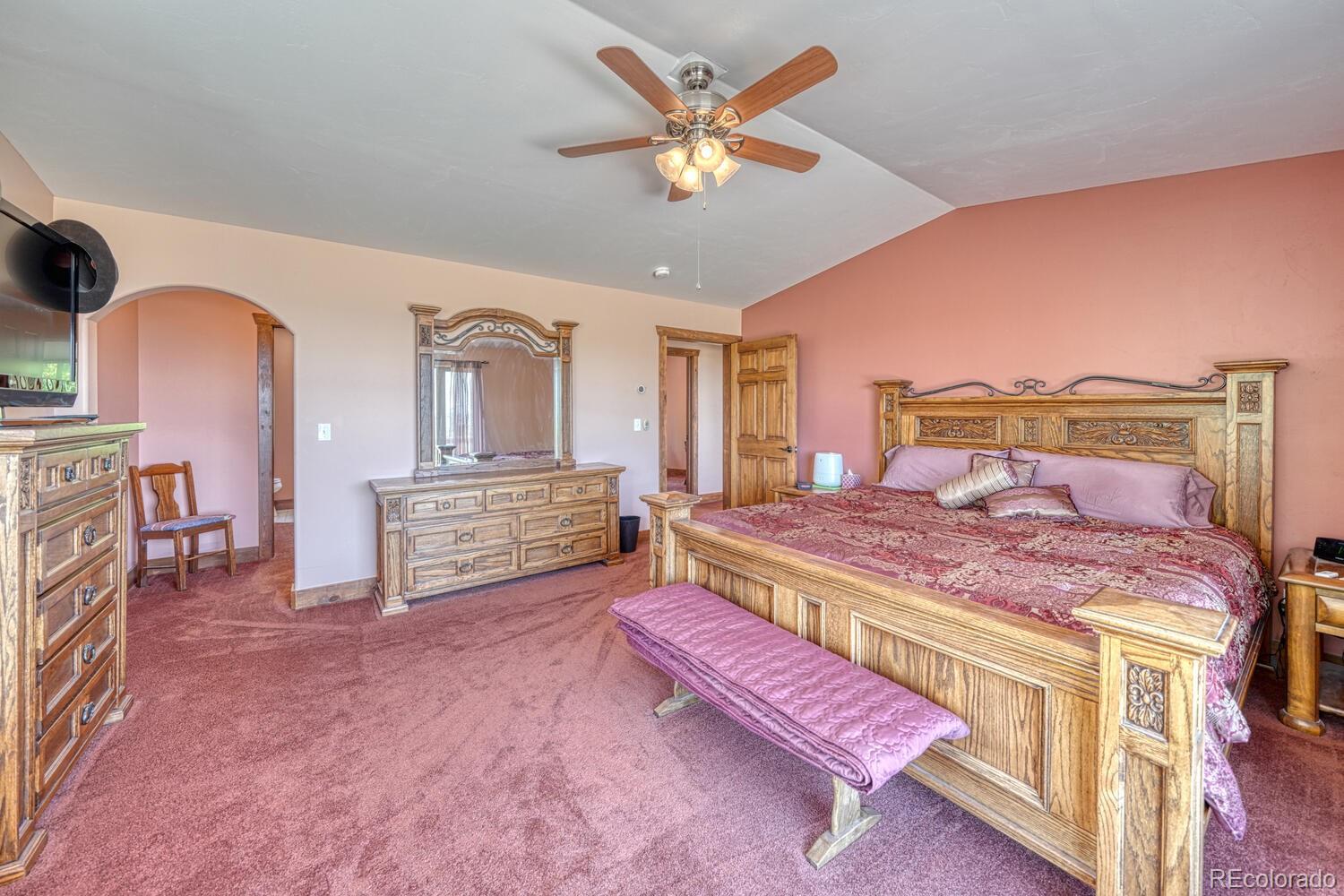 441 Kaufman Road Hartsel, CO 80449 - Photo 16 of 50 a spacious bedroom with a bed a dresser and potted plants