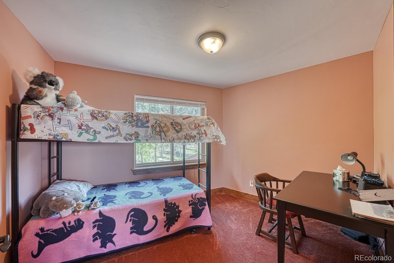 441 Kaufman Road Hartsel, CO 80449 - Photo 21 of 50 a bedroom with a bed and a table