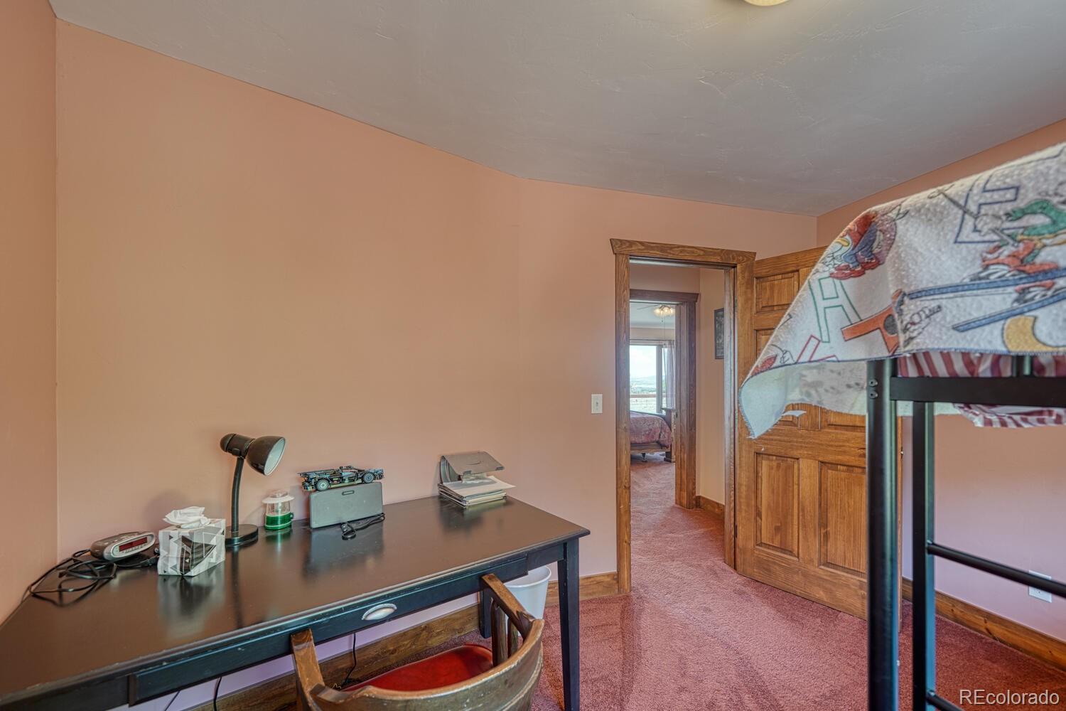 441 Kaufman Road Hartsel, CO 80449 - Photo 22 of 50 a view of a workspace with furniture and wooden floor