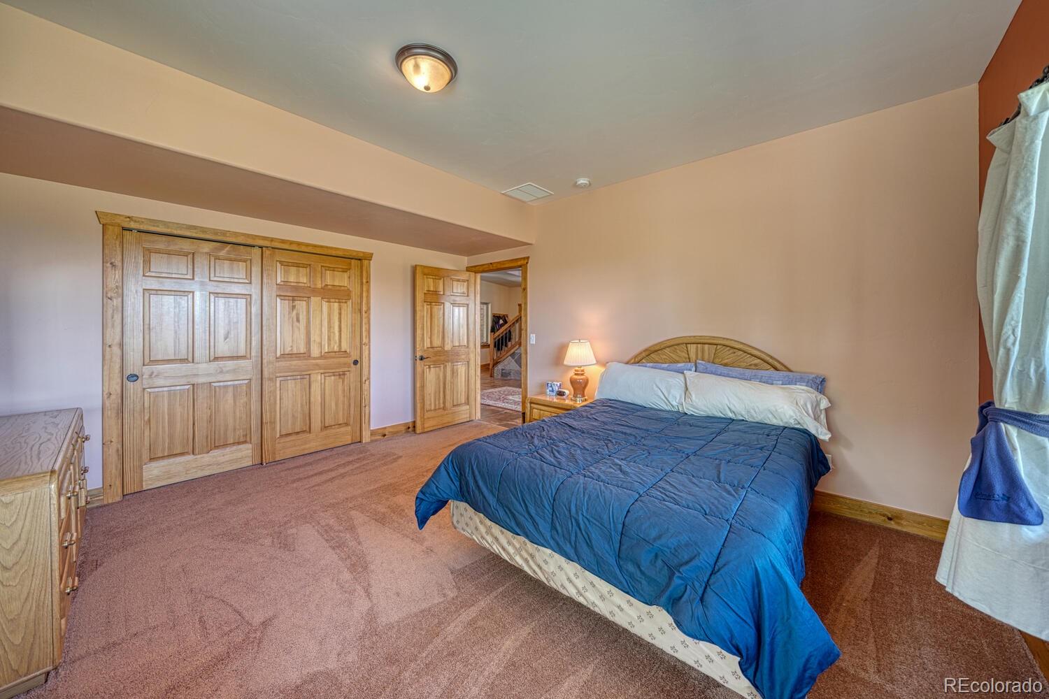 441 Kaufman Road Hartsel, CO 80449 - Photo 25 of 50 a bedroom with a large bed and wooden floor