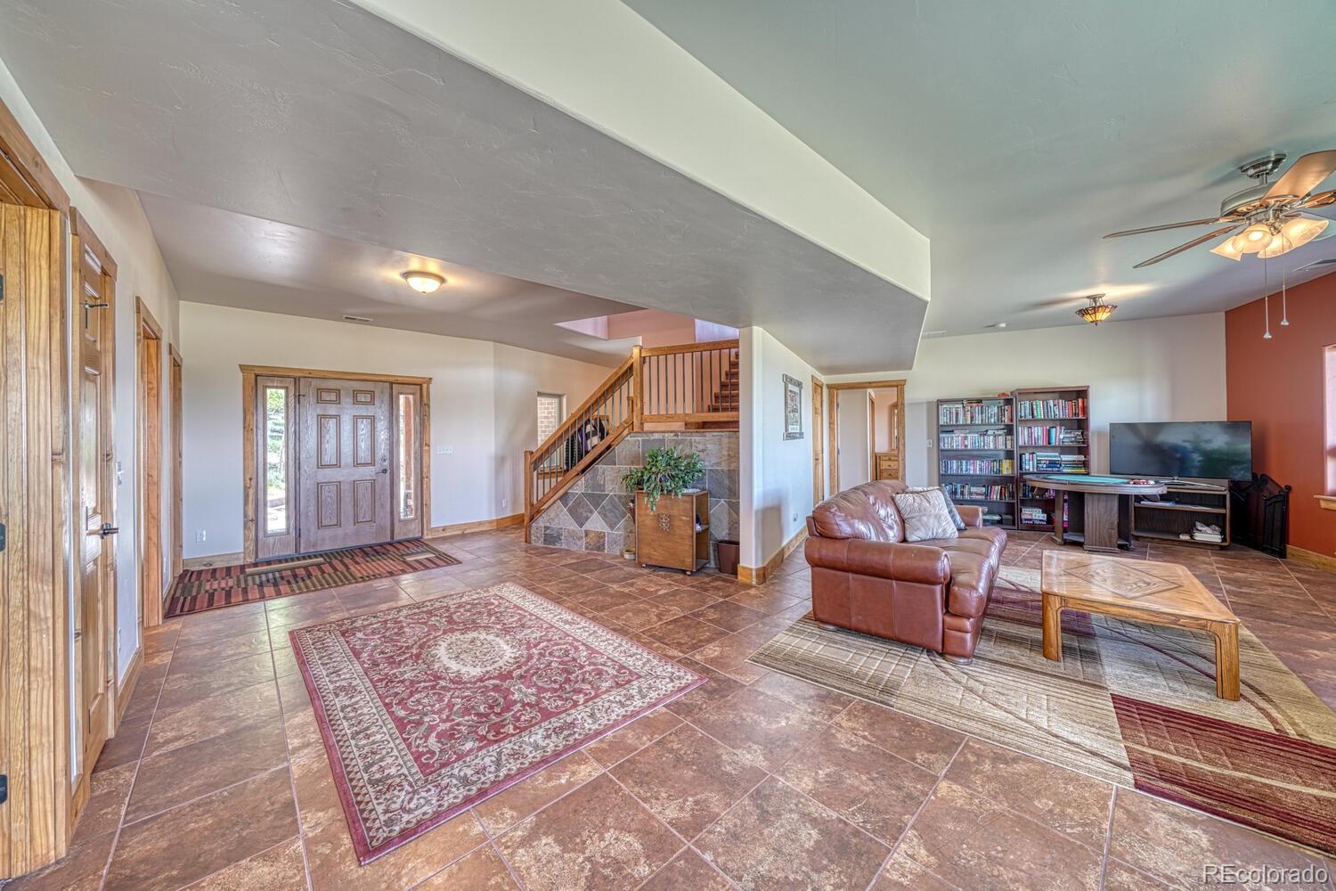 441 Kaufman Road Hartsel, CO 80449 - Photo 35 of 50 a living room with furniture a flat screen tv and rug floor