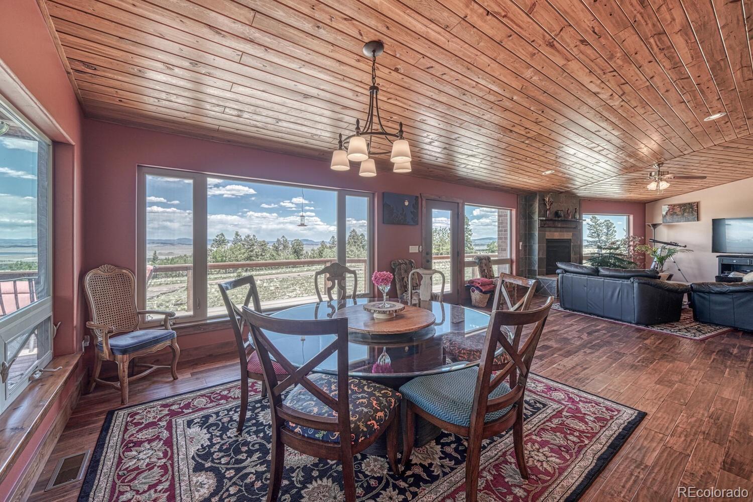 441 Kaufman Road Hartsel, CO 80449 - Photo 9 of 50 a view of a dining room with furniture wooden floor and chandelier