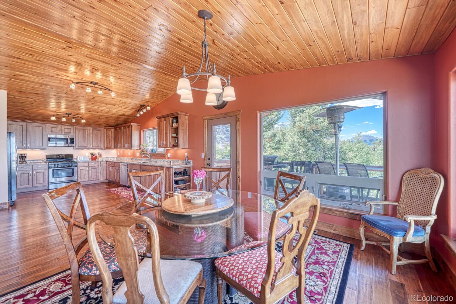 441 Kaufman Road Hartsel, CO 80449 - Photo 10 of 50 a view of a dining room with furniture wooden floor and a chandelier