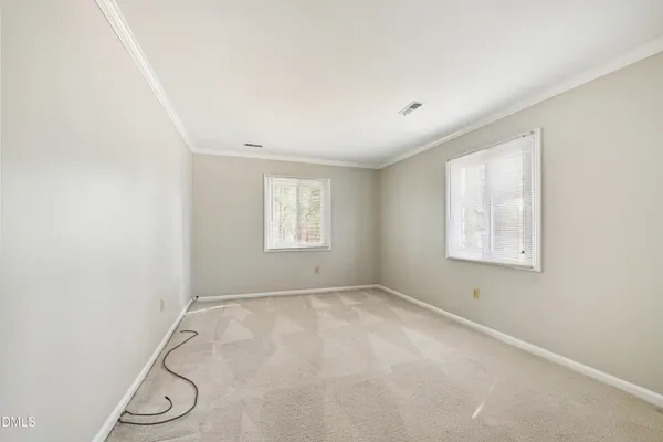 an empty room with windows and closet