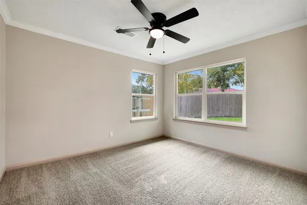 a view of an empty room with a ceiling fan