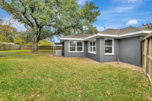 a view of a backyard with a tree
